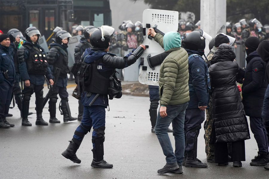 Участник протеста возвращает щит полицейскому, Алматы, Казахстан, 5&nbsp;января 2022&nbsp;года
