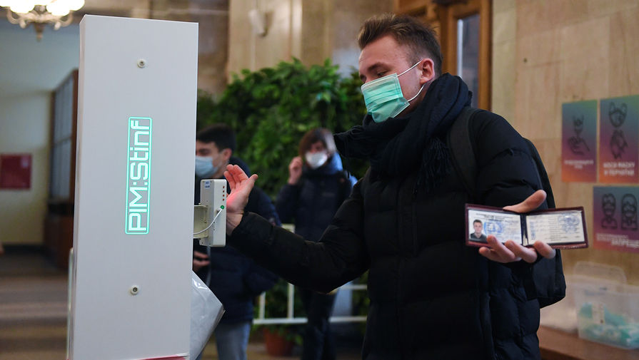 Студент в&nbsp;защитной маске измеряет температуру на&nbsp;входе в&nbsp;здание Московского государственного университета имени М. В. Ломоносова, 8&nbsp;февраля 2021&nbsp;год