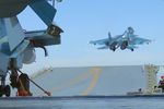 Истребитель Су-33 производит взлет с палубы тяжёлого авианесущего крейсера «Адмирал Флота Советского Союза Кузнецов» у берегов Сирии в Средиземном море. Крейсер «Адмирал Кузнецов» и СКР «Адмирал Григорович» впервые задействованы в операции в Сирии