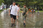 Горожане во время ливня в Москве, 15 июля 2025 года