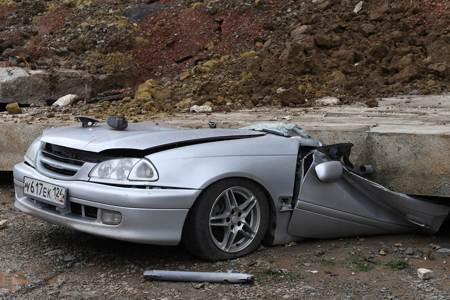 Легковой автомобиль, раздавленный обрушившейся подпорной стеной, возле жилого дома на проспекте 60-летия образования СССР в Красноярске, 6 августа 2021 года