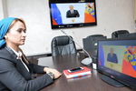 Сотрудница МЧС России по Чеченской Республике смотрит телевизионную трансляцию послания президента РФ Владимира Путина к Федеральному Собранию