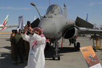 Мужчина фотографируется на фоне истребителя Dassault Rafale на Международном авиационно-космическом салоне Dubai Airshow-2023 в Дубае