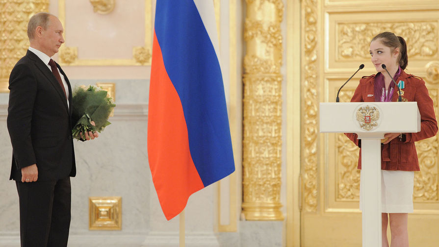 Президент России Владимир Путин на торжественной церемонии вручения государственных наград российским олимпийцам в Александровском зале Большого Кремлевского дворца. Справа — олимпийская чемпионка по спортивной гимнастике Алия Мустафина, 2012 год