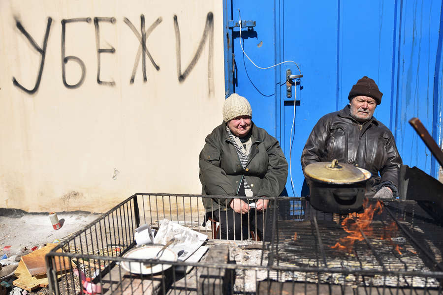 Местные жители готовят пищу у&nbsp;бомбоубежища в&nbsp;Мариуполе, март 2022&nbsp;года