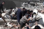 Выжившие жители дежурят у разрушенных домов и помогают разбирать завалы, под которыми могут отказаться их родственники.